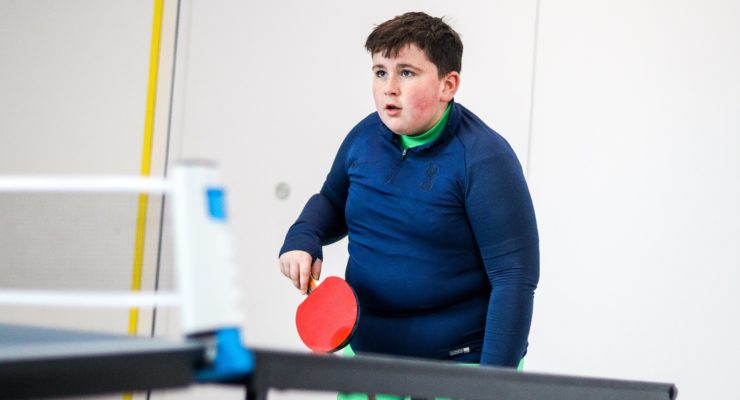 Young participant plays table tennis