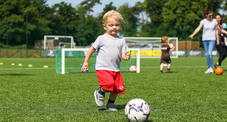 Young player kicks ball