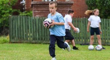 Young participant enjoys PE session at Kenninghall Primary
