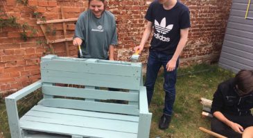 National Citizen Service participants paint furniture at The Nest