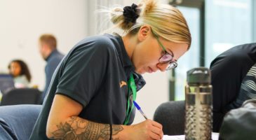 Staff member writing a thank you card