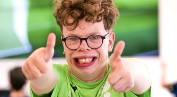 boy showing two thumbs up