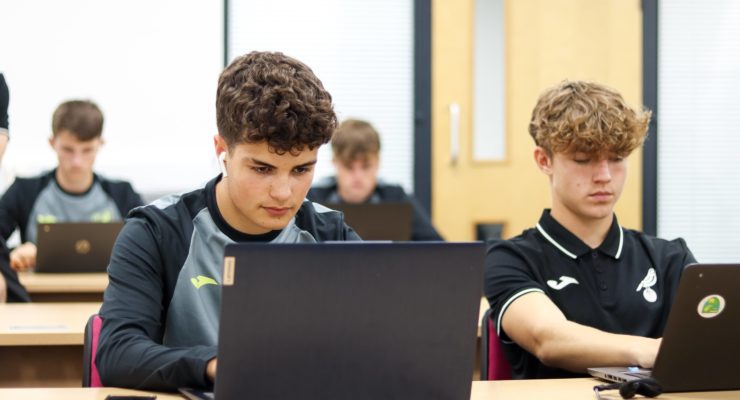 Boy reading from computer