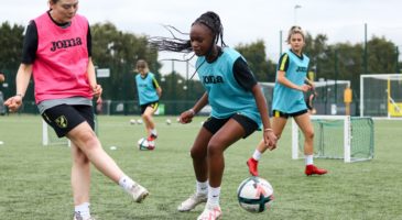 girl kicking football