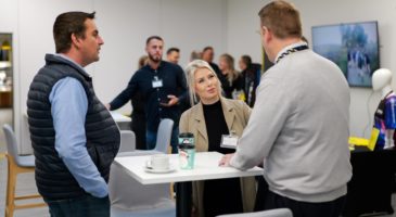 Two men and a woman networking