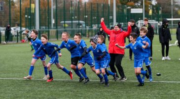 Children celebrating at football