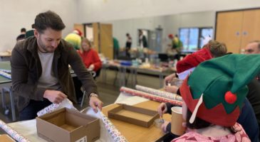Wes Hoolahan helping wrap a shoebox