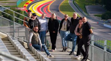 group of people in front of the Spa race track 