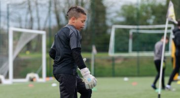 Boy in goalkeeper kit playing football