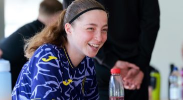 Girl sitting down laughing