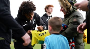 Sam McCallum signs young Norwich player's shirt