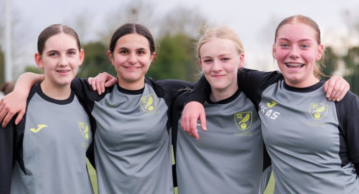 Four girls with their arms round eachother