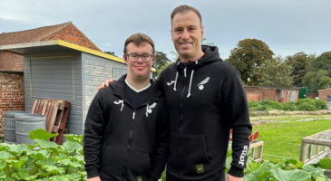 Ashley Barnes poses with DS football participant at The Nest