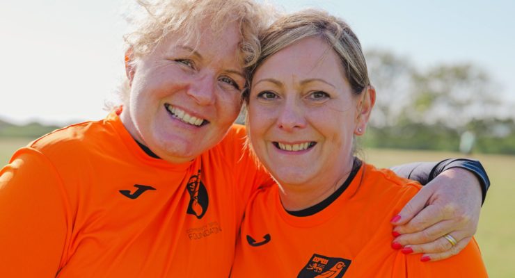 two women in orange tops