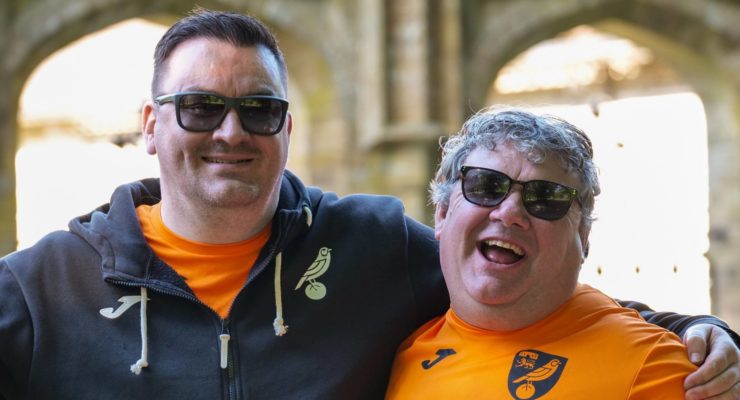 Two men laughing with thumbs up