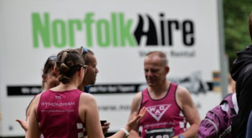 Runners in front of Norfolk Hire van