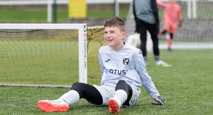Smiling goalkeeper wearing Norwich kit
