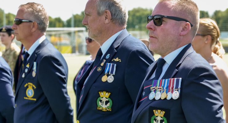 Military personnel standing to attention