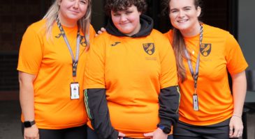 three women in orange tops 