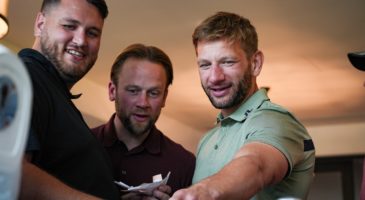 Three men looking at something