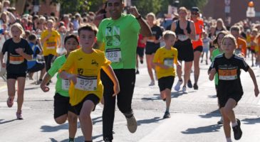adults and children running 