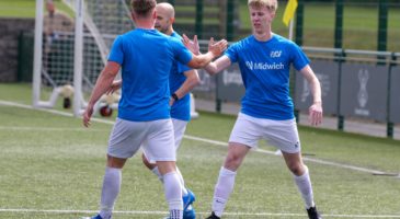 two men in blue and white football kit giving each other a high five