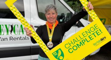 woman holding challenge complete sign
