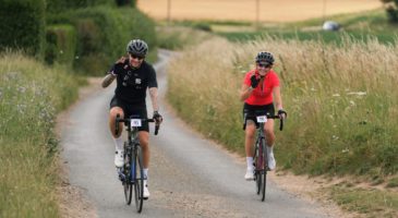 two people riding bicycle on country lane