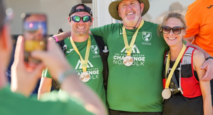 two men and a woman with medals around their necks