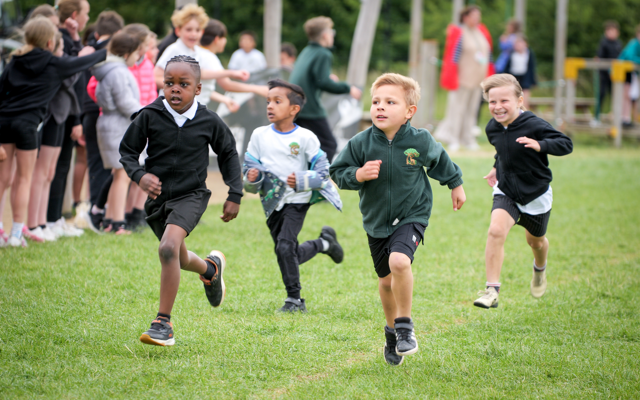 group of children running on grass