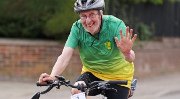 man in green and yellow top cycling