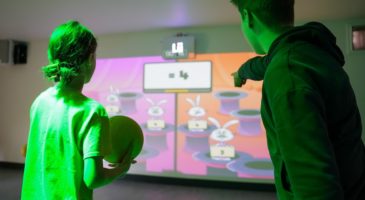 two people using an interactive wall
