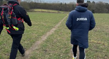 two men walking away from the camera