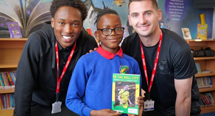 Errol Mundle-Smith and Kenny McLean meet a pupil at Wensum Junior School