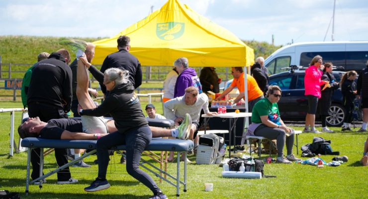 Group of people sitting and receiving sports massage