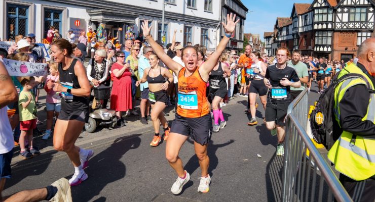A runner celebrating in Run Norwich 2025