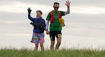 a woman and a man waving