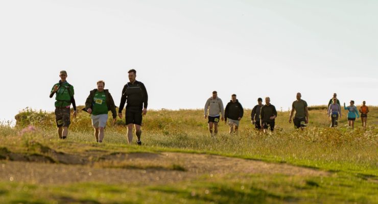 Group of people walking along the coast