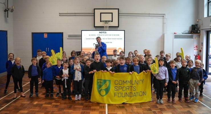 Group of children holding a banner saying community sports foundation