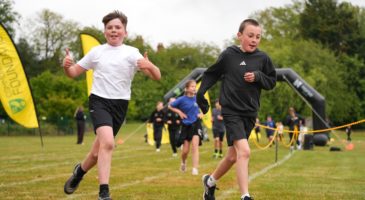 two boys running and smiling