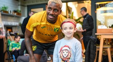 a norwich city player standing next to you boy