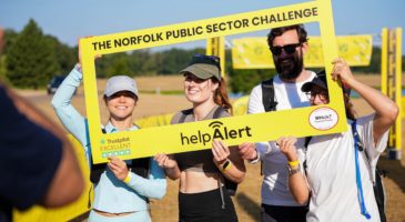 three women and a man behind a frame that says the norfolk public sector challenge