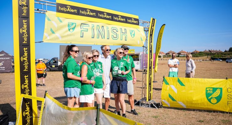 Group of people standing underneath a finish banner