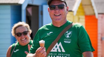 a man with an ice cream and a woman smiling behind him