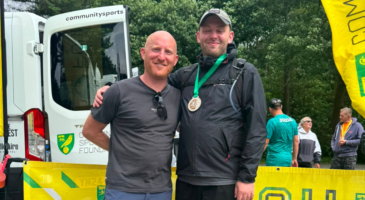 two men, one with a medal around his neck