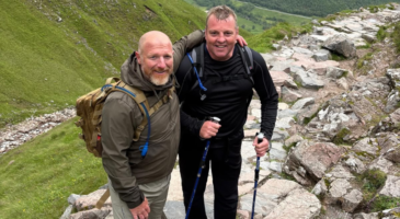 two men walking up a mountain path